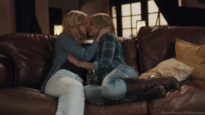 Long legged Serene Siren & Charlotte Stokely kissing on sofa